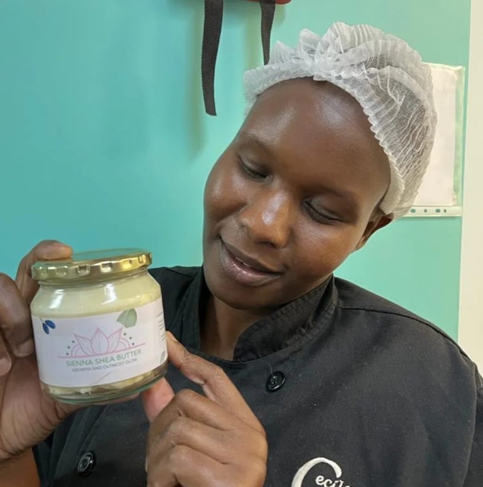 A customer proudly showing her Sienna Shea Butter