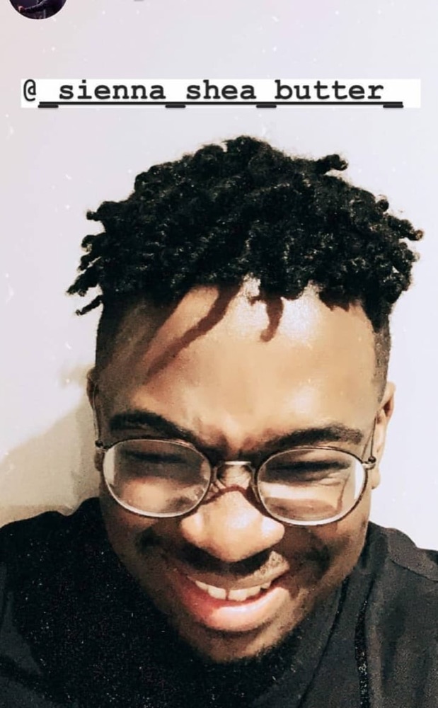 A customer showing his moisturised natural hair