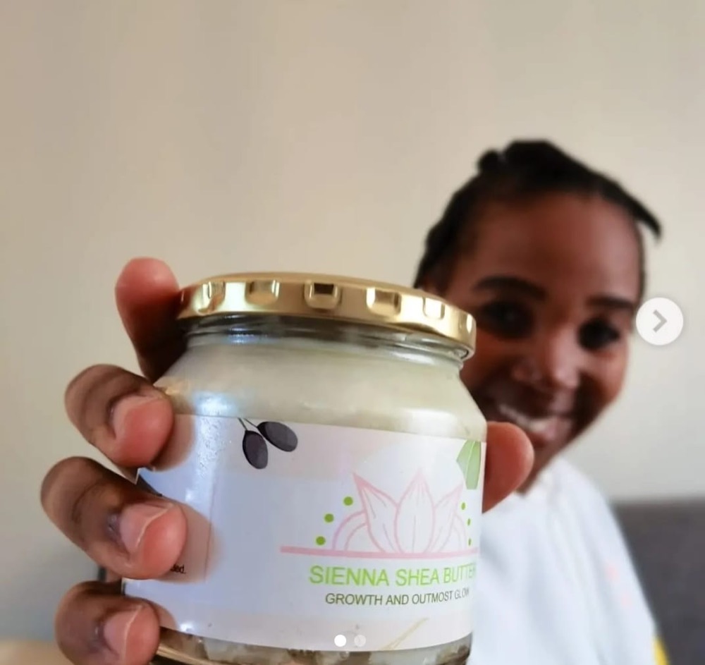 A close-up of Sienna Shea Butter in a customer’s hand