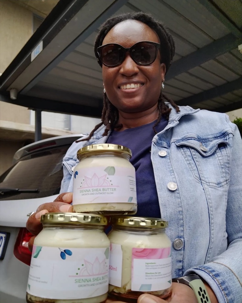 A customer collecting three jars of Sienna Shea Butter