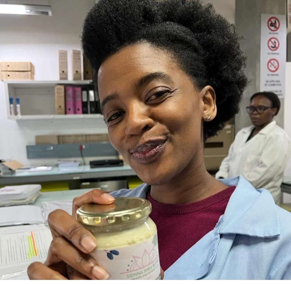 A customer holding Sienna Shea Butter at work